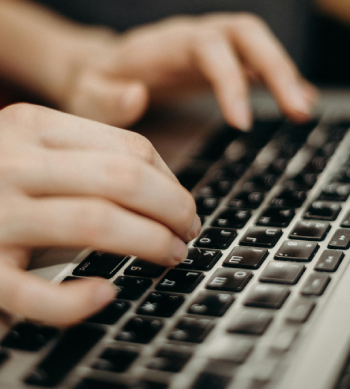 Hands typing on a keyboard