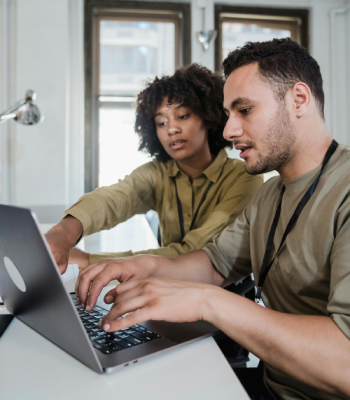Two people looking at a laptop